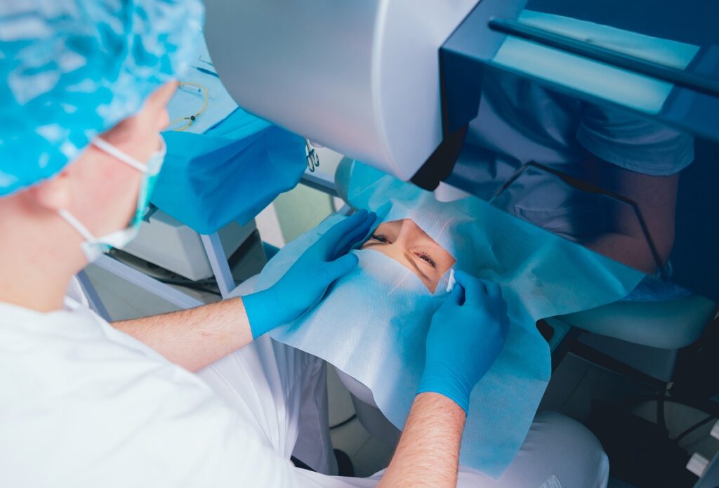 A patient and team of surgeons in the operating room during ophthalmic surgery