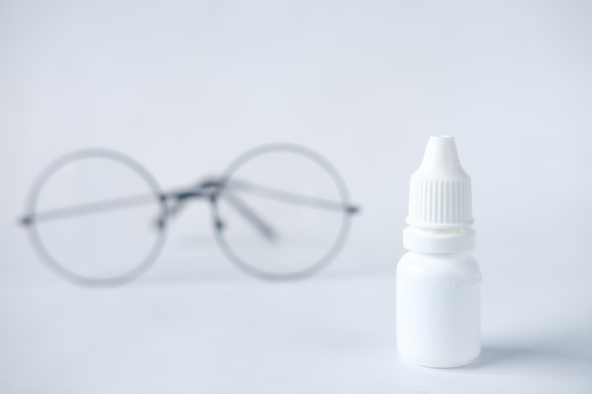 eye drop bottle and eyeglass